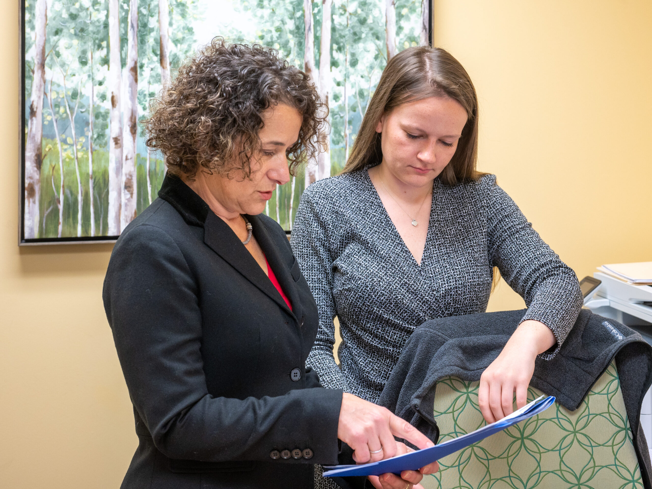 Staff of Brooker Memorial review a report together.