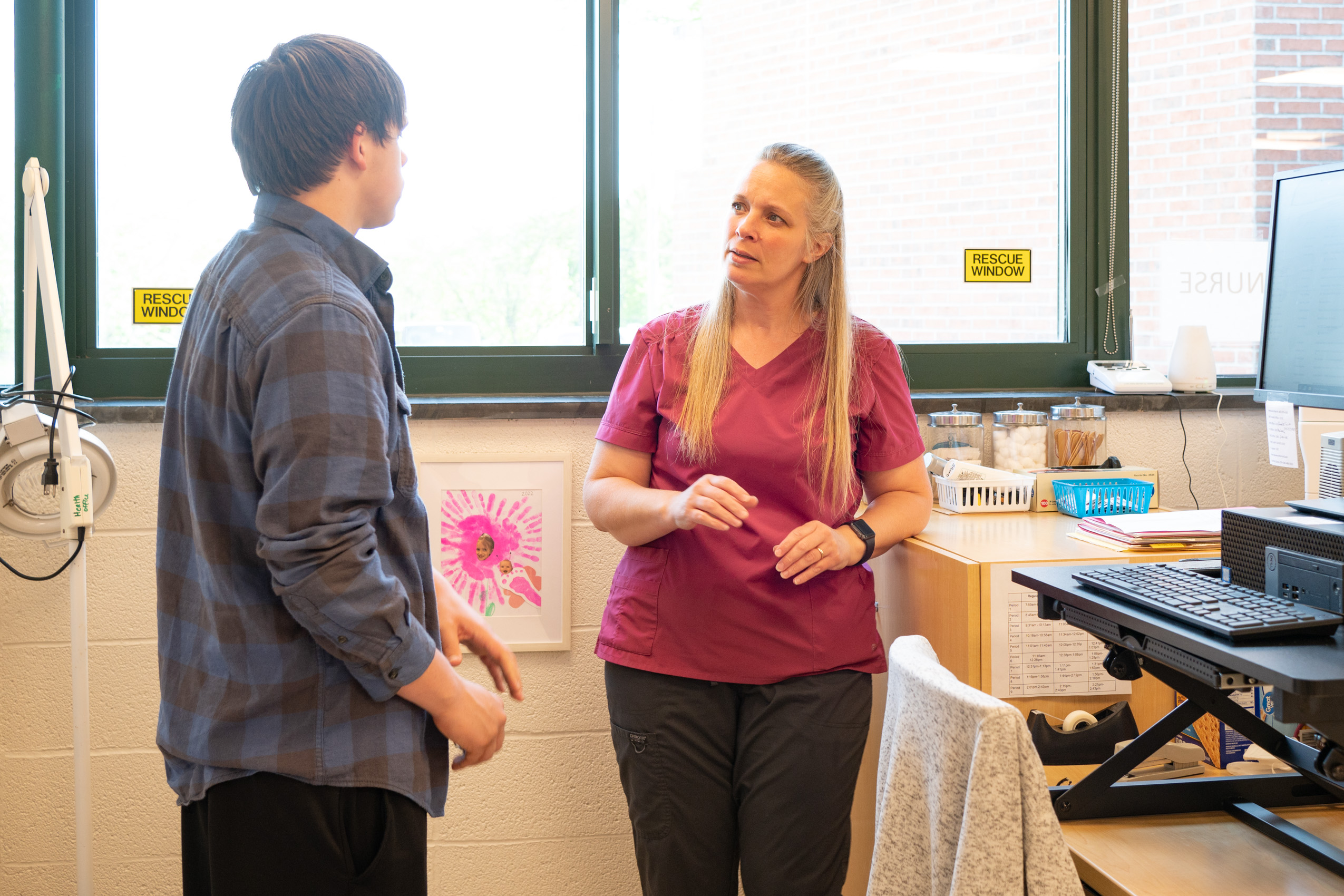 School-based health center personnel talks with a student of Webutuck Central School District.
