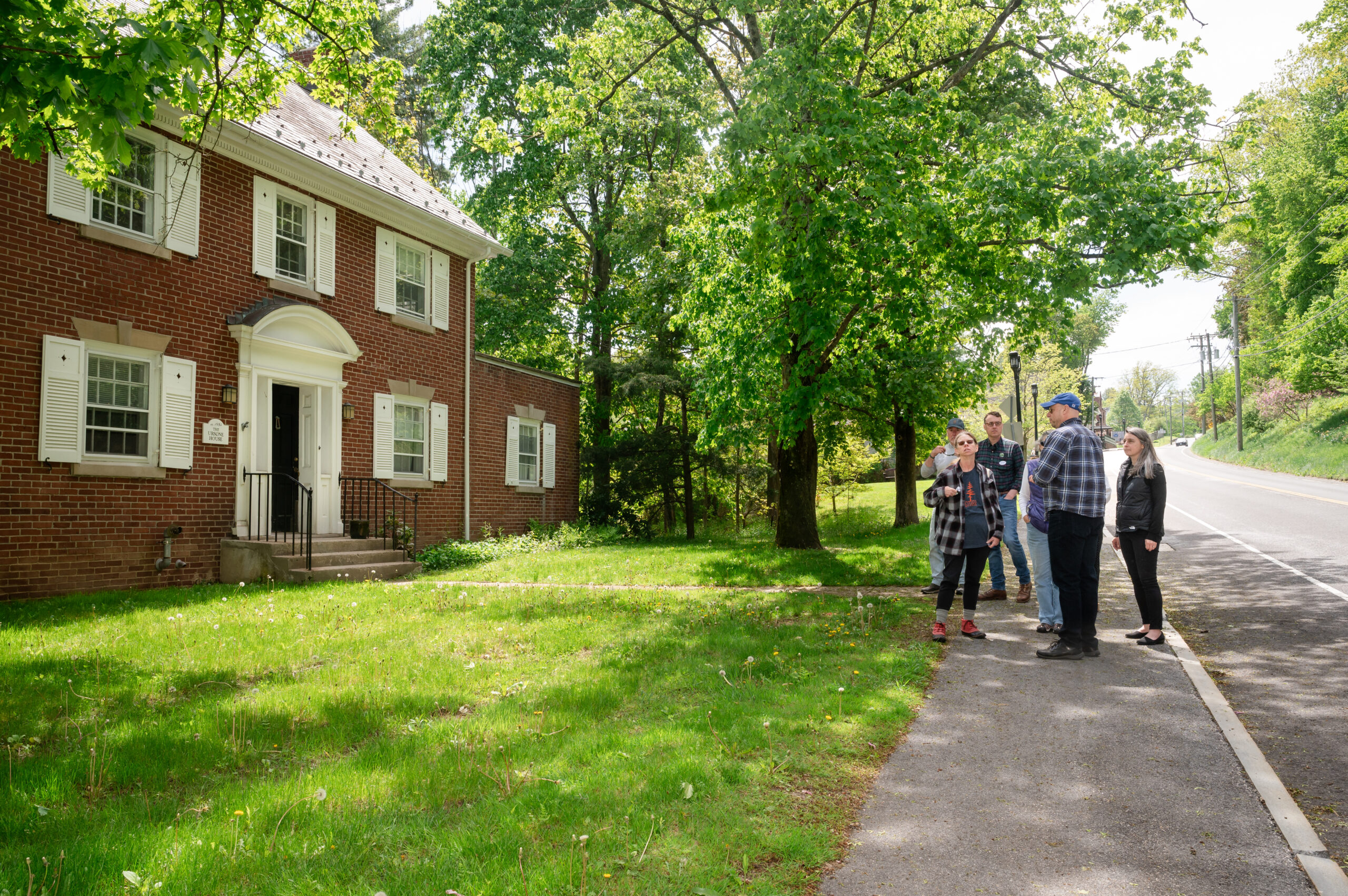Affordable housing and conservation group members gathered in front of affordable housing building.